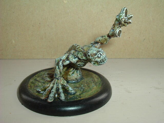 Painted miniature of a gnarled tree stump on a black round base