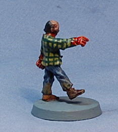 Photograph of a small walking figurine in a plaid shirt and red gloves on a round base.