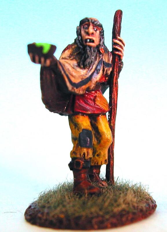 Painted miniature of a ragged wizard holding a staff on a grassy base