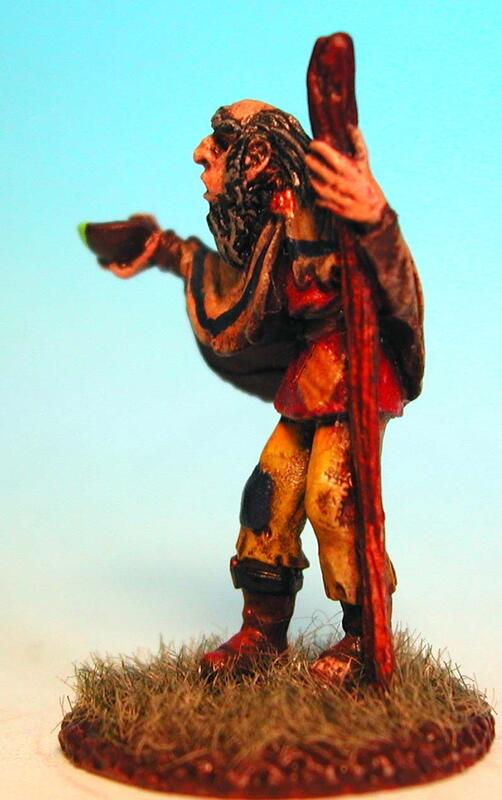 Painted miniature of a hunched figure with staff on a grassy base