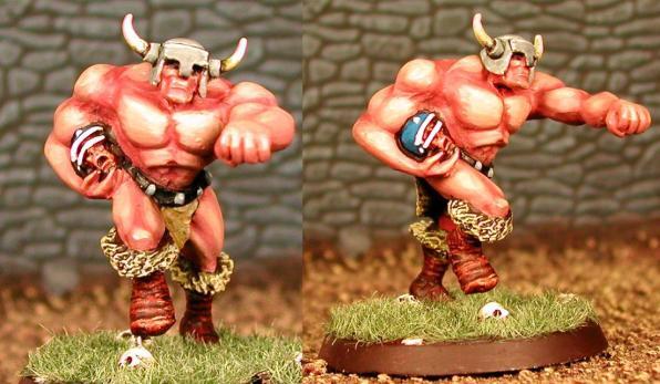 Two horned, muscular red minotaur miniatures on a stone-floor background.