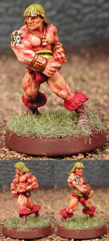 Painted miniatures of three muscular red warriors on grass-textured round bases.