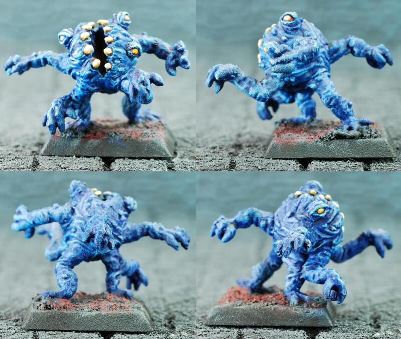 Four views of a blue horned monster miniature on a tabletop base.