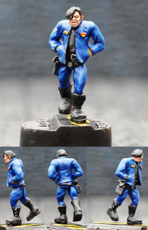 Photo of painted blue sci-fi soldier miniature from multiple angles on a stand.
