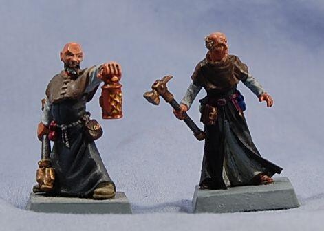 Photo of two painted fantasy miniatures: a dwarf with lantern and a robed axe-wielder.