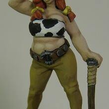 Hand-painted figurine of a horned woman in green pants, leaning on a large axe.